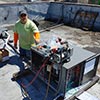 K & D technician installing rooftop unit