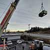 Crane lifting rooftop unit